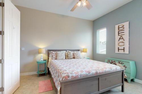 a bedroom with a bed and a ceiling fan at Campeche Retreat #2 in South Padre Island