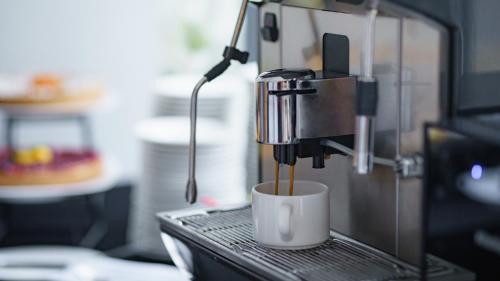 a coffee machine sitting on top of a desk at Artis Loft Hotel in Radziejowice