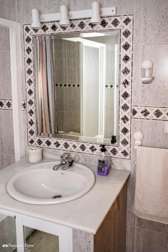 a bathroom with a sink and a mirror at Villa Cristina in Benaoján
