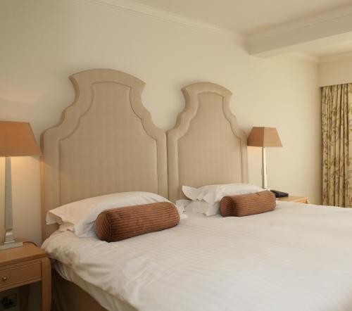 A bed or beds in a room at Grayshott Health Spa 