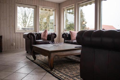 a living room with couches and a coffee table at Stora Herrestad B&B in Ystad