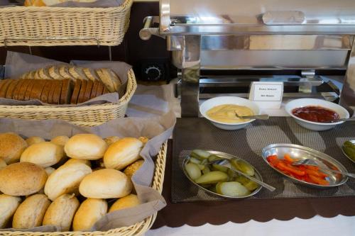 a bunch of baskets of bread and vegetables on a counter at Aparthotel Bellamonte in Zakopane