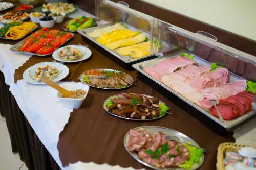 a buffet with many different types of food on a table at Aparthotel Bellamonte in Zakopane