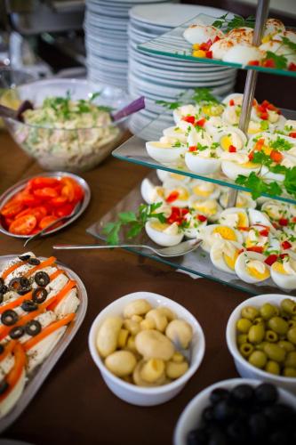 a table topped with plates of food and bowls of food at Aparthotel Bellamonte in Zakopane