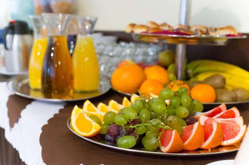 a table topped with plates of fruit and drinks at Aparthotel Bellamonte in Zakopane