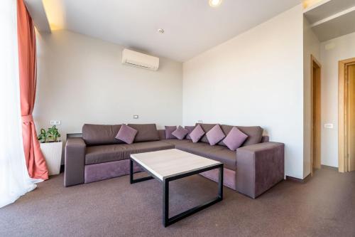 a living room with a couch and a table at Mini-hotel People in Odesa