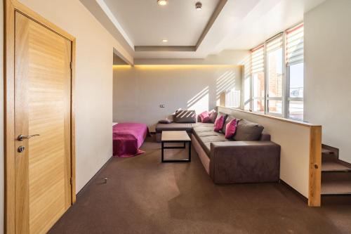 a living room with a couch and a bed at Mini-hotel People in Odesa