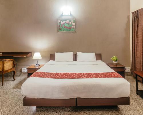 a bedroom with a large bed in a room at Hanu Reddy Residences Wallace Garden in Chennai