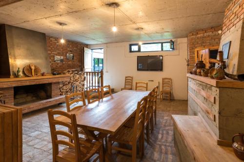 a dining room with a large wooden table and chairs at Alliance Hotel in Tbilisi City