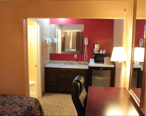 a hotel room with a bathroom with a sink at Valustay Inn Shakopee in Shakopee