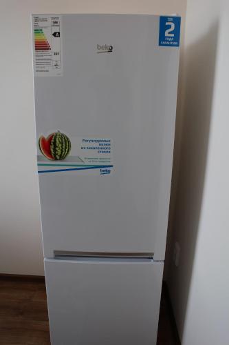 a white refrigerator with a box on top of it at Апарт отель Welcome in Taldykorgan