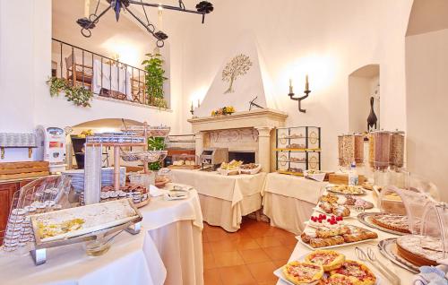 a restaurant with tables with food on them at Hotel Punta Est in Finale Ligure