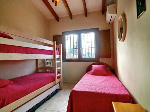 a bedroom with two bunk beds and a window at Villa Salinas in Calpe