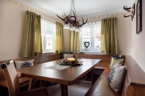 a dining room with a wooden table and chairs at Chalet Jagdhof in Sankt Johann im Pongau
