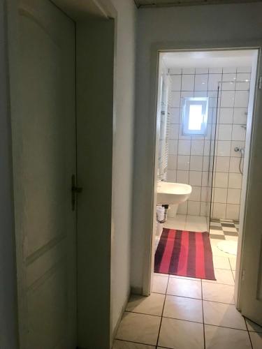 a bathroom with a toilet and a sink at JUNA in Karlsruhe