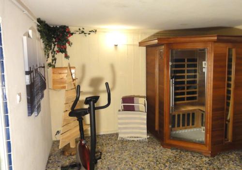 a room with a cabinet and a vacuum at La demeure aux Pins in Lourdes