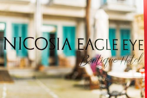 a sign that says noscega eagle eye with tables and chairs at NICOSIA EAGLE EYE in North Nicosia
