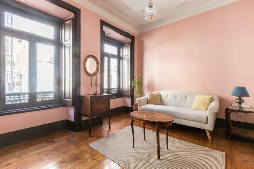 a living room with a couch and a table at Charming Guest House in a 19th Century Building in Lisbon