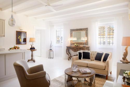 a living room with two chairs and a table at Old Town Luxury Suites 'Princess' in Corfu