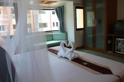 a room with two white swans on the floor at Your Place Inn in Karon Beach