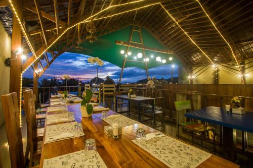 a row of tables in a restaurant with a view at Green Hill Boutique Hotel in Labuan Bajo