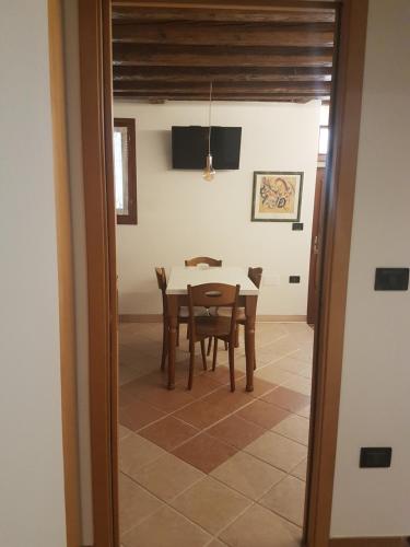 a dining room with a table and chairs at Corte dei Bari in Venice