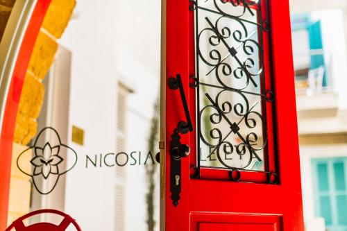 a red door in front of a building at NICOSIA EAGLE EYE in North Nicosia