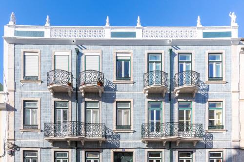 a building with balconies on the side of it at Charming Guest House in a 19th Century Building in Lisbon