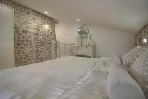 a bedroom with a large bed and a mirror at ADORA in Motovun