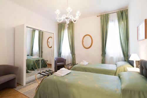 Habitación con 2 camas y espejo. en Residenza Procuratie Due, en Venecia