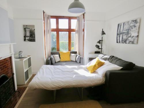 un dormitorio con una cama y una ventana en Lyndale House - Exclusive use, self catering, fpventures Stroud, en Stroud