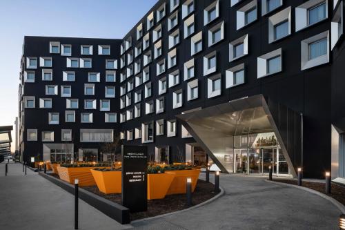 a rendering of a building with orange and black at INNSiDE by Meliá Paris Charles de Gaulle Airport in Roissy-en-France