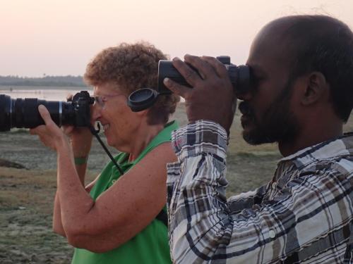 a man and a woman taking pictures with cameras at El Shaddai in Mannar