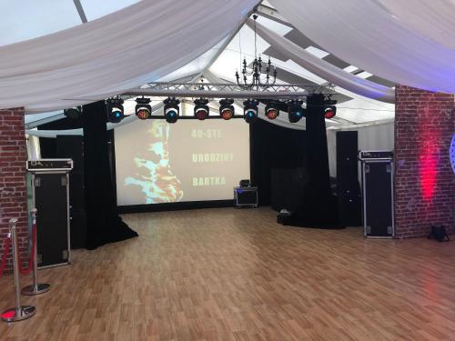 a white tent with a projection screen in a room at RJ Hotel in Pabianice