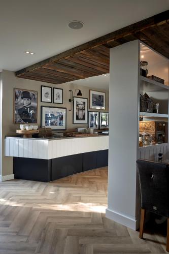 a room with a counter with photos on the walls at Hotel Heer Hugo in Heerhugowaard