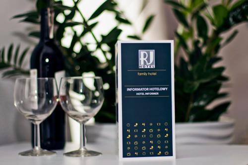 a calendar next to two wine glasses on a table at RJ Hotel in Pabianice