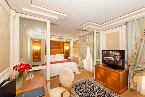 a hotel room with a bed and a television at Swiss Diamond Hotel & Spa in Morcote