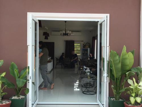 a person standing in a room with plants at avalon residence2 in Savannakhet