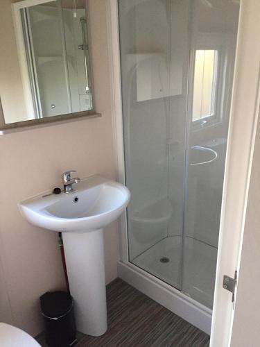 a bathroom with a sink and a shower at Sdr. Felding camping & hytteby in Sønder Felding