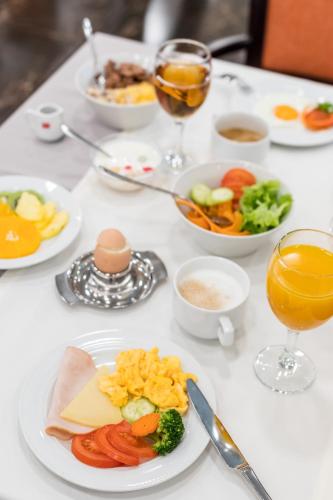 a white table topped with plates of food and drinks at Hotel Mondo in Split