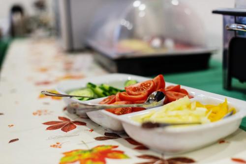 a plate of food on a counter with vegetables at Hotel Patriot in Vranov nad Topľou