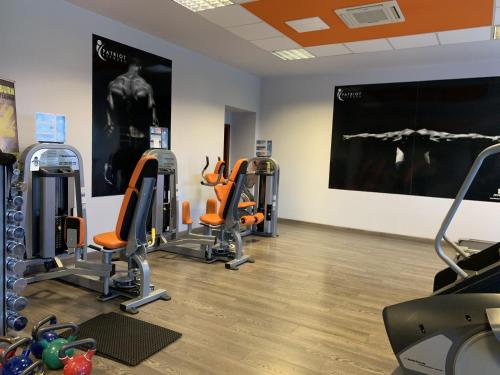 a gym with a row of exercise bikes in a room at Hotel Patriot in Vranov nad Topľou