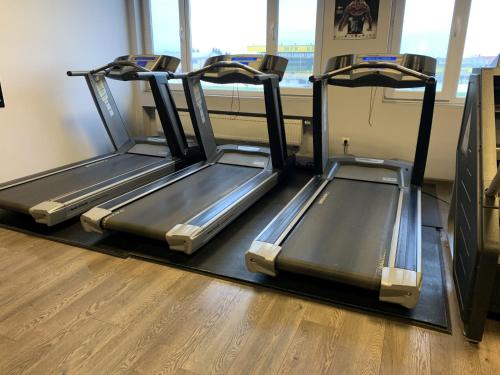 two treadmill machines in a room with a window at Hotel Patriot in Vranov nad Topľou