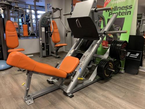 a gym with orange chairs and a treadmill at Hotel Patriot in Vranov nad Topľou