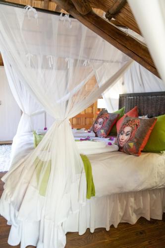 a bedroom with a bed with a canopy at Blyde River Canyon Lodge in Hoedspruit