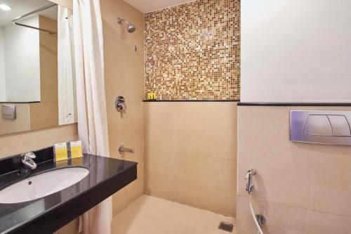 a bathroom with a sink and a shower at Keys Select by Lemon Tree Hotels, Katti-Ma, Chennai in Chennai