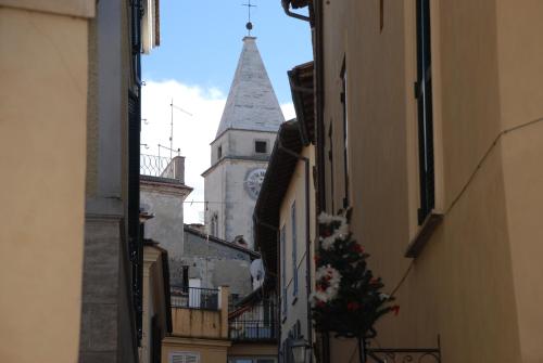 a steeple of a building with a clock tower at La Palombara in Ponzano Romano