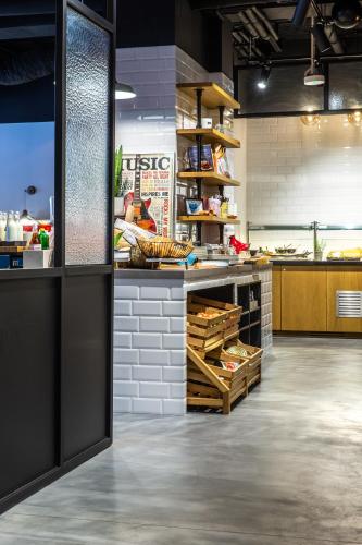a large kitchen with a counter with food at Park Inn by Radisson Poznan in Poznań