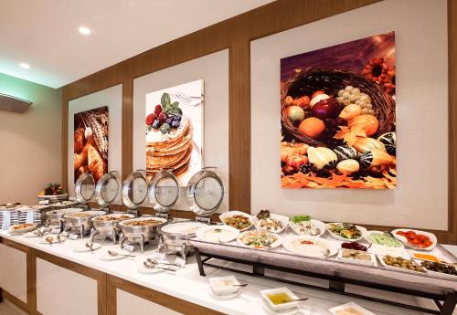 a buffet line with many plates of food at Al Sarab Hotel in Dubai