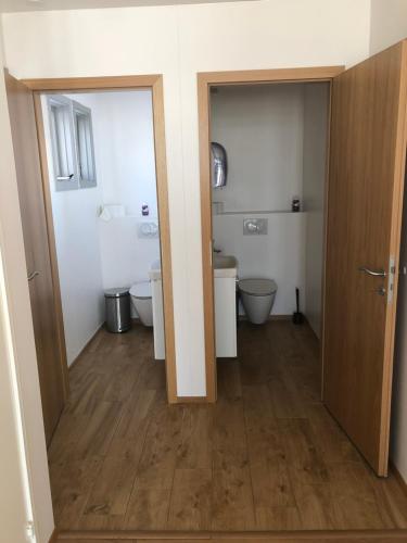 a bathroom with two toilets and two sinks at Vestmannsvatn Guesthouse in Aðaldalur